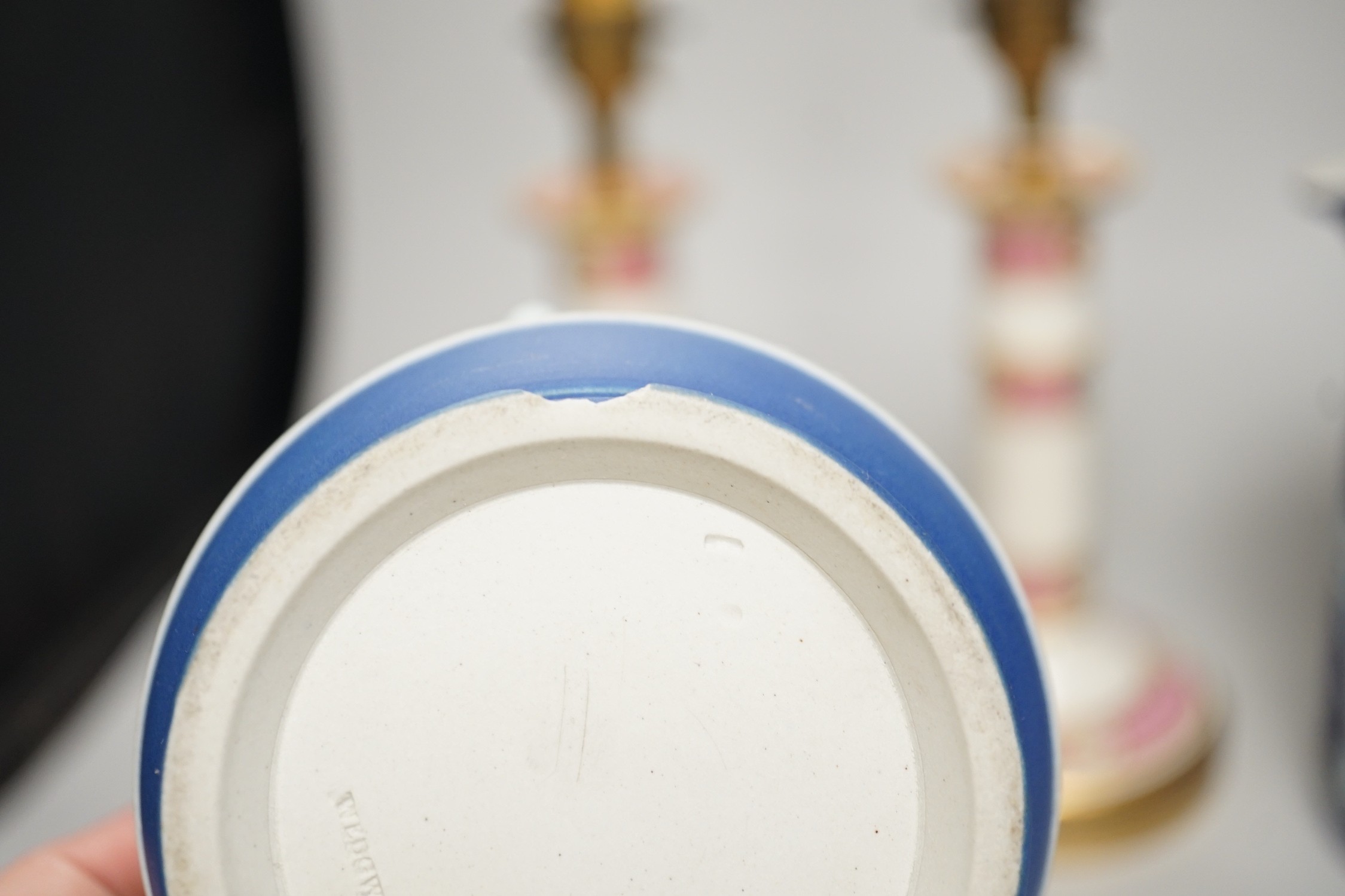 Three mid to late 19th century pieces of Wedgwood Jasperware, including a coffee pot and a small cache-pot, a pair of 19th century porcelain candlesticks converted into lamps